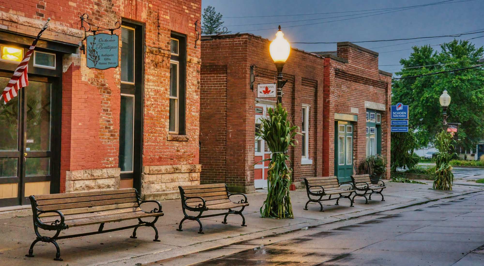 A small-town main street lined with brick storefronts and local shops