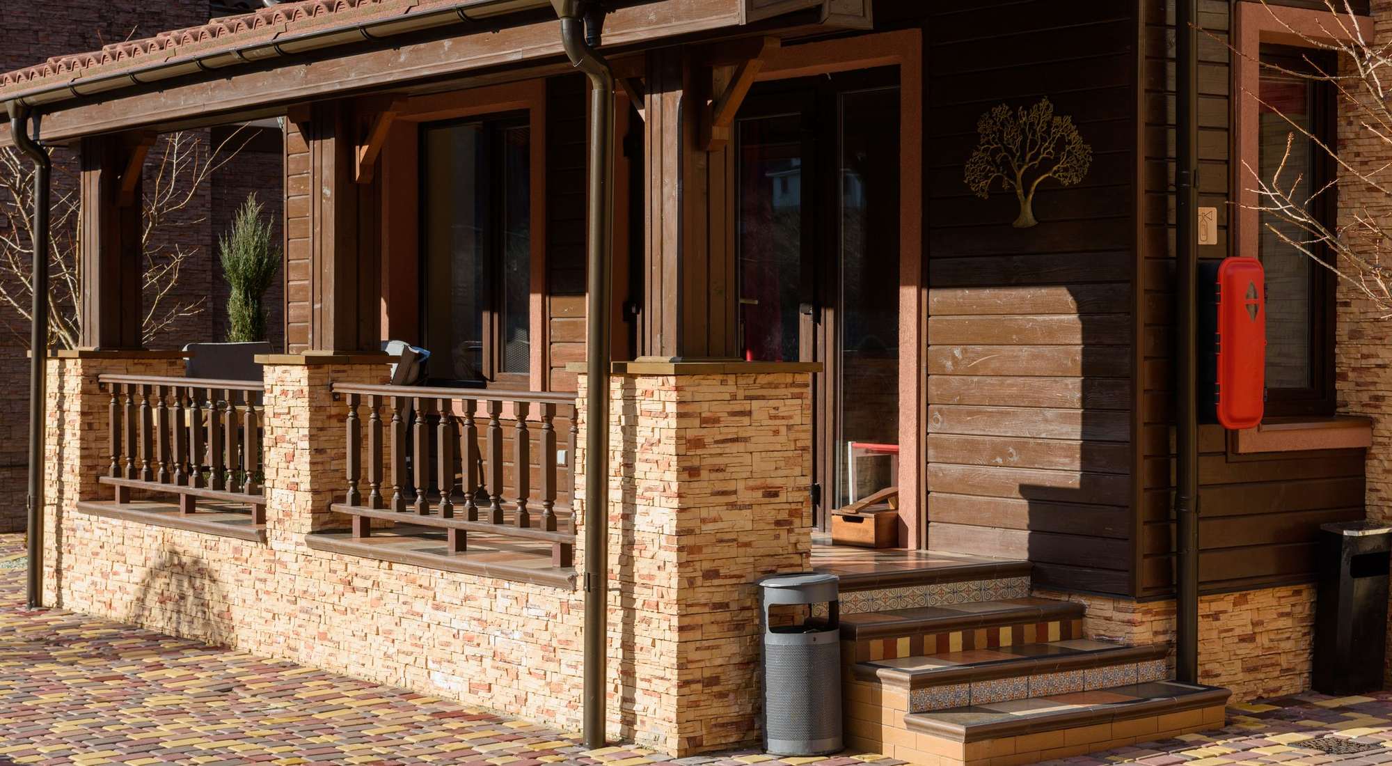 The wood-and-stone exterior base of a home where termites typically enter near the foundation